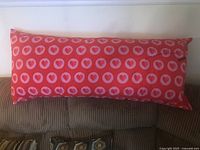 Full view of the red body pillow on sofa