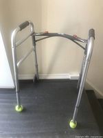 Full view of Drive Medical walker showing frame, wheels and tennis-ball glides