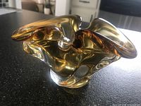 Three-quarter view showing overall freeform shape and amber coloration