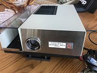 Front and side view of Hanimex Hanomat Auto 1000 projector showing lens and branding