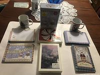 All lot contents laid out: three packaged Hallmark card sets, two mugs