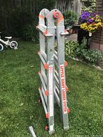 Folded Little Giant ladder showing orange locks and branding