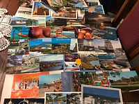 Fronts of assorted international color postcards spread on table