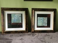 Both framed prints side by side on sofa