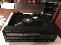 Overall view of stereo with dust cover open showing turntable and Elvis record