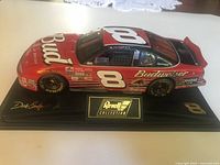 Full left-front view of the 1:24 die-cast car on display base