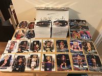 Overview of card lot on table with storage box labeled “WWE cards”