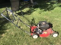 Left side view of Toro red deck lawn mower on grass