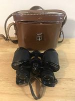 Front view of binoculars and closed leather case