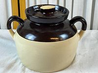 Front view of two-tone stoneware bean pot with lid attached