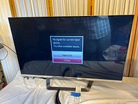 Front view of LG 47-inch TV powered on displaying no-signal message