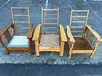 Front view of three oak Morris armchairs side by side
