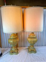 Full view of both ceramic urn table lamps with shades
