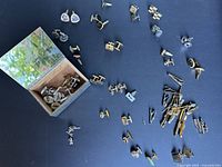 Overall view of cufflinks, tie clips and silver plated box spread on surface