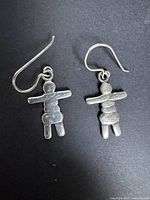 Front view of both sterling Inukshuk earrings