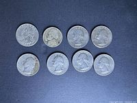 All eight coins front side