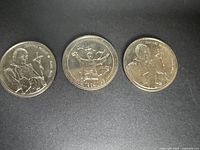 Three papal visit commemorative coins side by side