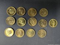 Group of 14 bronze-tone commemorative medals on black background