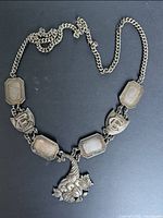 Full view of necklace showing chain, links and central pendant