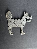 Front view of sterling silver dog brooch