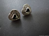 Front view of both heart earrings showing marcasite border and black stone centers
