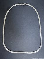 Full view of sterling silver necklace laid flat