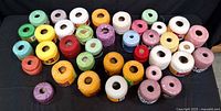 All spools laid out to show quantity, colours and intact paper bands