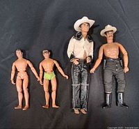 Front view of four articulated figures showing clothing and accessories