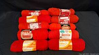 Ten red yarn skeins displayed; highlights different labels