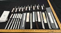 All knives laid out showing variety, sleeves, handles and box