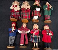 Front view eight vintage Christmas caroler figurines, two rows