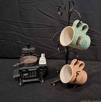 Overall lot with toy stove, mugs on stand, toothpick holder visible