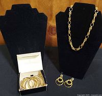 Overview with necklace on stand, earrings below, box of bangles on left