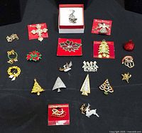 Overview of 18 Christmas themed brooches laid out