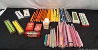 Full lot overview showing tapers, spiral tapers, tealight packs and boxed candles