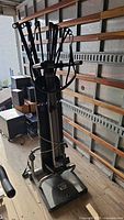 Front view of Bowflex home gym showing foot platform, central column, power rods and cables