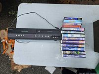 Funai combo unit top view with stack of VHS tapes