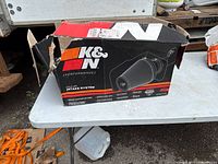 Torn K&N cold air intake system box on table