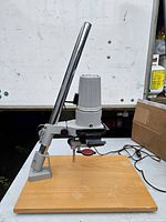 Full view of enlarger on baseboard showing column, enlarger head, power cord