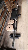 Bench, barbell, two plates on bench
