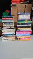 Front view of two stacks of paperback books showing titles and authors