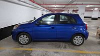 Left side profile of blue 2016 Nissan Micra in parking garage