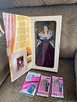 Doll box opened with trading card packs displayed