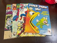 Four comic books laid out showing covers