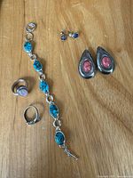 Group shot of all jewelry pieces on wood surface