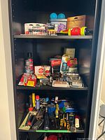 Full cabinet view showing all tools and packaged items across shelves