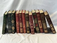 Front view of all 12 leather-bound books standing upright