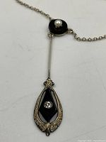 Close-up of pendant showing jet discs, seed pearl and gold detailing