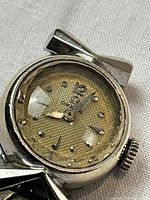 Close-up of dial showing Omega branding, hour markers and hands