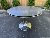 Full view of round chrome tulip table